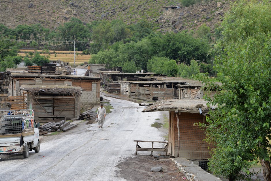 Women and children gathered outdoors in a rural Afghan community.